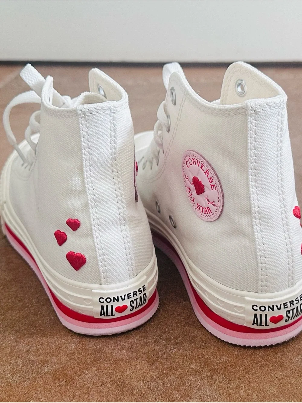 Converse White High-Top Sneakers with Pink Accents